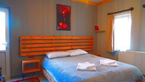 a bedroom with a bed with two towels on it at Alpha Stone House in Goreme
