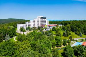 an aerial view of a building in the middle of a forest at AHORN Berghotel Friedrichroda in Friedrichroda