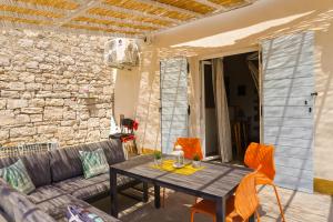 a living room with a couch and a table at Holiday Home Bezic in Grohote