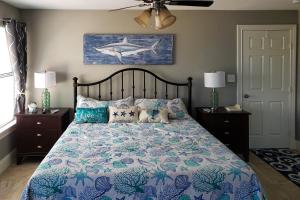 a bedroom with a large bed with a shark painting on the wall at Jamaican Waves in Galveston