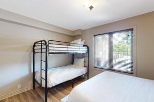 a bedroom with two bunk beds and a window at Sierra Lane 105 in Blue Mountains