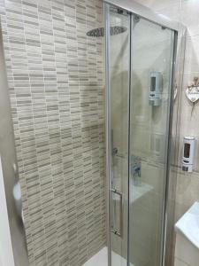 a bathroom with a shower with a glass door at La casa dei nonni in Bari +12 photos