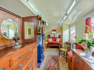 a kitchen with a large wooden dresser and a living room at Mahalia in Fordham