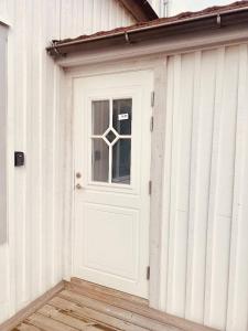 a white door on the side of a building at Lovely 2-bed Flat In Stockholm in Sollentuna