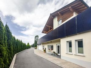 a house with a black roof and a road at Apartment Wesseling in Fontanella