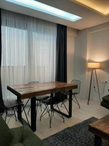 a dining room with a table and chairs in a room at Unuvar home in Kuşadası