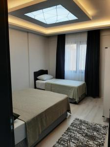 a bedroom with two beds and a skylight at Unuvar home in Kusadası