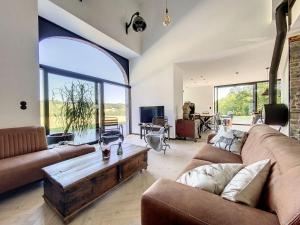 a living room with a couch and a coffee table at Villa Wapiti in Aywaille