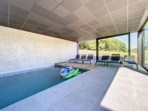 a swimming pool in the middle of a house at Villa Wapiti in Aywaille