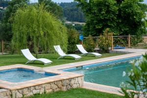 two chairs and a swimming pool in a yard at Jordan's Stone House in Siviri +38 photos