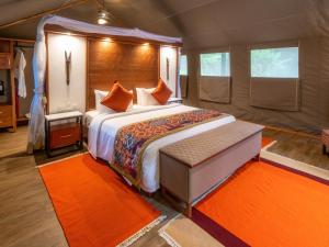 a bedroom with a bed in a tent at Sarova Mara Game Camp in Sekenani