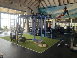 a gym with a woman jumping in the air at Ballito Sea Villa in Ballito