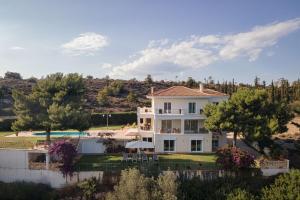 an aerial view of a house with a pool at Villa Fantasia Isthmia in Isthmia +61 photos