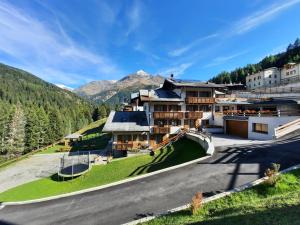 ein Resort in den Bergen mit einer Straße davor in der Unterkunft Chalet Primula 7 in Santa Caterina Valfurva