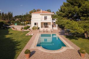 an aerial view of a house with a swimming pool at Villa Fantasia Isthmia in Isthmia