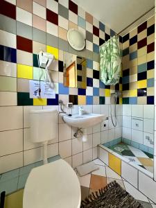a bathroom with a toilet and a sink at Leniwy Kot in Stegna +9 photos