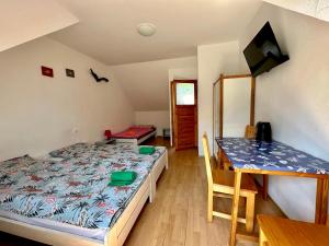a bedroom with a bed and a dining table at Leniwy Kot in Stegna