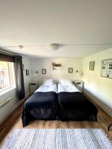 a bedroom with a large bed in a room at STF Korrö Hotell in Linneryd