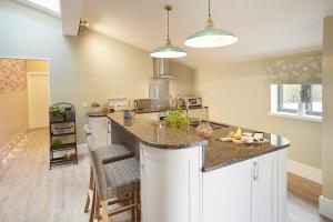 a kitchen with a large island with a counter top at The Gardener's Bothy in Shifnal