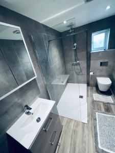 a bathroom with a sink and a shower and a toilet at Deluxe 2 Bedroom Apartment in Sheffield +55 photos