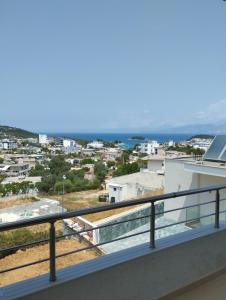 a balcony with a view of a city at Ahmeti Rooms in Ksamil