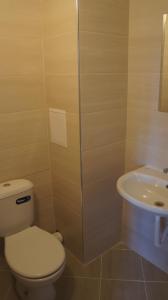 a bathroom with a toilet and a sink at Къща за гости Валена град Черноморец in Chernomorets