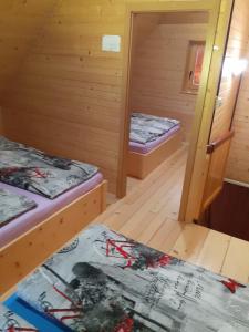 a room with two beds in a cabin at Brunarica na Goreljeku in Bohinj
