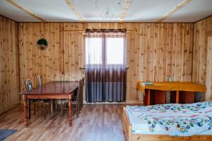 a bedroom with a bed and a desk and a table at Przy Trójstyku in Dubeninki