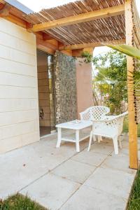 a patio with a white bench and a pergola at Relax in Vieste