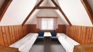 Postel nebo postele na pokoji v ubytování Bungalovy Eroplán