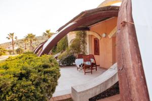 a patio with a table and chairs on a house at Relax in Vieste