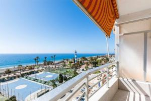 a balcony with a view of a pool and the ocean at A&N Nevada 76 in Torre del Mar