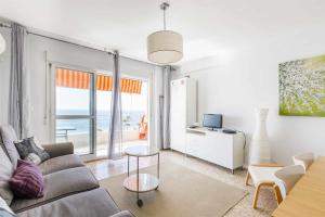 a living room with a couch and a view of the ocean at A&N Nevada 76 in Torre del Mar