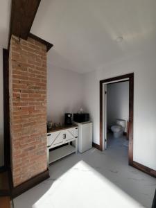 a bathroom with a toilet and a brick wall at Stone House Kenora in Kenora