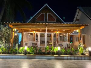 a pavilion with tables and chairs at night at Hotel Caribbean Coral in San Andrés