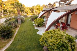a garden with a tent and chairs and plants at Relax in Vieste