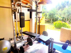 a room with a gym with dumbbells and weights at TETRAKTYS estate in Ágios Matthaíos