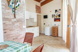 a kitchen with a table and chairs and a brick wall at Relax in Vieste