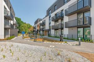 an empty street in front of apartment buildings at GRANO FLATS Sobieszewo - Baltic Line in Gdańsk