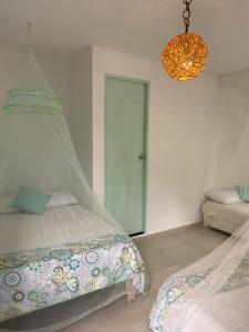a bedroom with a bed and a chandelier at Massalli Sanctuary Lodge in San Andrés