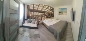 um quarto com uma cama, um sofá e uma cadeira em Apartament Olomouc NEW1 em Olomouc