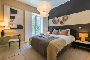 une chambre avec un lit, une table et une lampe dans l'établissement Liberdade Elegance W/Rooftop Pool by LovelyStay, à Lisbonne