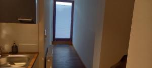 a hallway leading to a bathroom with a sink and a window at Weingut Fehres in Brauneberg +25 photos