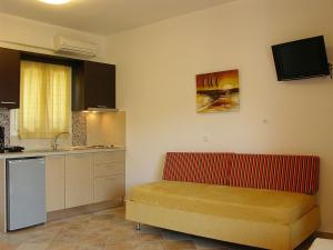 a kitchen with a red bench in a room at Dafni studios nο3 in Parga