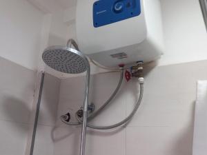 a shower in a bathroom with a water tank at FG Homestay, Kampala Muyenga-Bukasa in Kampala