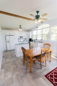a dining room with a table and chairs and a kitchen at Cache Rapids Vacation Rental in Reidville