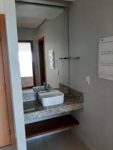 a bathroom with a sink and a mirror at SALINAS EXCLUSIVE RESORT in Salinópolis