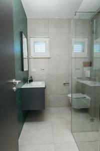 a bathroom with a sink and a toilet at Apartments Seafront in Pupnat