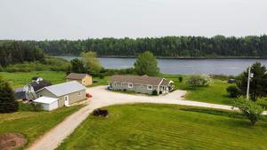 an aerial view of a house with a lake at Cache Rapids Vacation Rental in Reidville