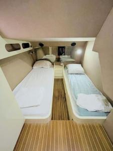 a small room with two beds on a boat at Séjour insolite à bord d'un Yacht à Porto Vecchio in Porto-Vecchio